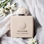 Amouage Love Tuberose Eau de Parfum bottle displayed in a luxury setting, highlighting its creamy white floral fragrance with vanilla undertones.