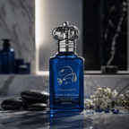 Clive Christian Jump Up and Kiss Me Addictive Arts Hedonistic luxury Eau de Parfum in a blue bottle with silver crown cap on premium marble background.